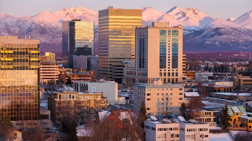 Downtown Anchorage skyline with the Chugach Mountains in golden hour light